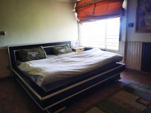a large bed in a bedroom with a window at Drowned in Clouds V2 in Nathia Gali