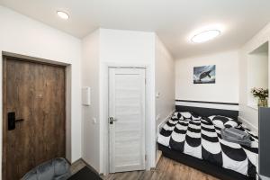 a bedroom with a black and white bed and a door at Riverra House in Kaunas +40 photos
