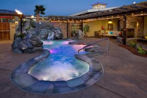 a swimming pool with a waterfall in a backyard at Best Western Plus Humboldt Bay Inn in Eureka