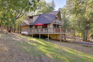 a large house with a porch and a deck at Spacious Groveland Cabin with Wraparound Deck! in Groveland