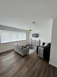 a living room with a couch and a chair at Inchmoan Apartment in Bonhill