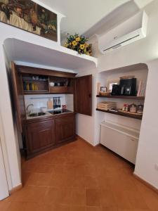 a kitchen with wooden cabinets and a counter top at Art House Centro - Gargano in San Giovanni Rotondo