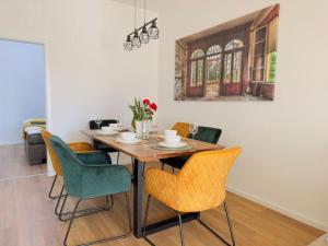 une table de salle à manger avec des chaises et un tableau au mur dans l'établissement FeWo für 7 Personen/Netflix/Parking/WLAN/stilvoll, à Pöttmes 37 autres photos