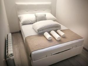 - un grand lit blanc avec 2 oreillers dans l'établissement Hisa idej, à Sežana