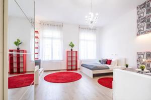 a living room with a bed and red rugs at Super central convenient apartment in Budapest