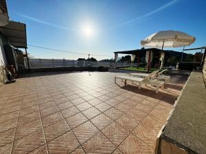 a bench and an umbrella on a patio at Acquamarina in Gaeta