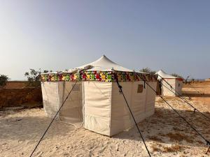 a white tent in the middle of the desert at Caves Camp Matrouh in Kafr Abu Habhab +14 photos
