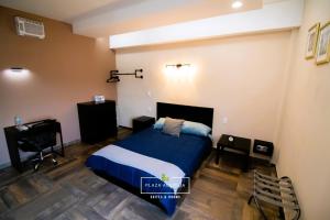 um quarto com uma cama, uma secretária e uma cadeira em A02 Full Suite ‖ Mini Dept at Plaza Acequia em Cuautitlán Izcalli