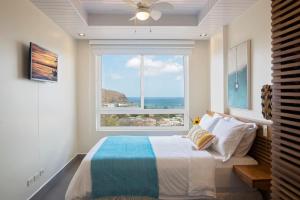 a bedroom with a bed and a large window at La Santa Maria Resort in San Juan del Sur +285 photos