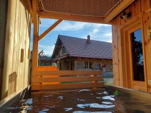 Cottage Golenovo في Podvelka: مقعد خشبي أمام المنزل