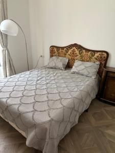 a bed with a white comforter and pillows in a bedroom at La Victoire in Monte Carlo +17 photos