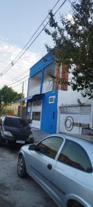 a silver car parked in front of a blue building at Pousada Recanto Boituva in Boituva