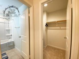 a bathroom with a walk in shower and a door at Bella's sweet house 11155 in Mira Loma +114 photos