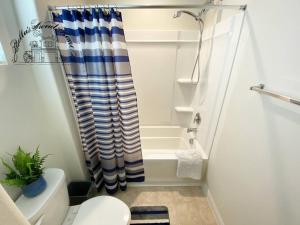 a bathroom with a shower curtain and a toilet at Bella's sweet house 11155 in Mira Loma