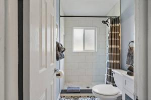 a white bathroom with a toilet and a shower at Malyn 108, Updated Waterfront condo, private patio in St Pete Beach +22 photos