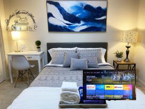 a bedroom with a bed with a laptop on it at Bella's sweet house 11155 in Mira Loma