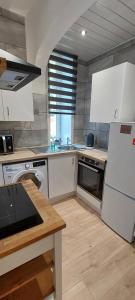 a kitchen with white cabinets and a white refrigerator at Paisley Pattern Flat West End UWS UNI GLA Glasgow Airport in Elderslie