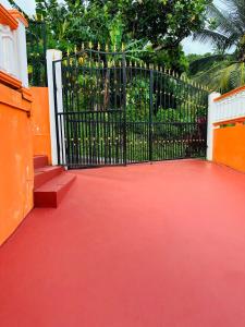 a black gate with a red floor and a red carpet at Fraser's Suites in Kingstown