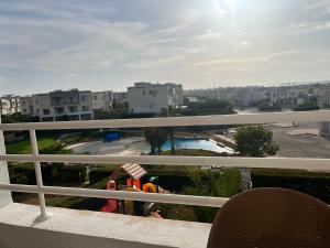 a balcony with a view of a pool and buildings at شاليه في امواج amwaj in El Alamein