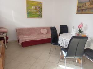 a living room with a table and a couch at Apartment Rina - Old Town in Dubrovnik