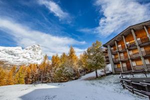 a ski lodge in the mountains with snow on the ground at Marcolski Home 2 in Breuil-Cervinia