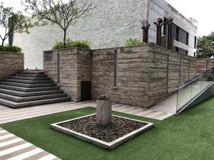 a building with stairs and a tree in a courtyard at CityScape Properties 2br AC 754 ft2 Amenities 24 hours Concierge in San José