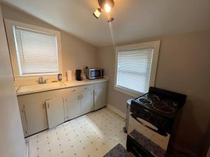 a kitchen with a stove and a sink at City Lights Retreat on 12th UAB in Birmingham