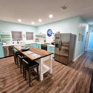a kitchen with a table and a refrigerator at Pat's Perch in Rockport