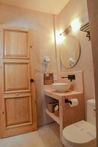 a bathroom with a sink and a toilet and a mirror at Hotel Mansión Chiapa in Chiapa de Corzo