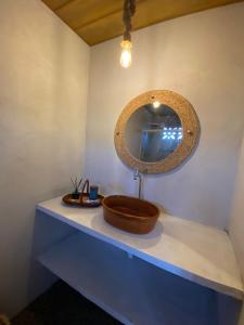 a bathroom sink with a mirror on a counter at Chalé dos ventos Macapá in Ponta do Anel