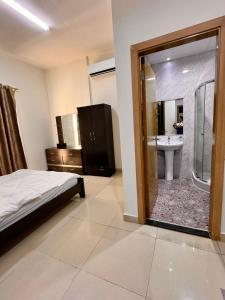 a bedroom with a bed and a bathroom with a shower at Sweet Living Homes Rental LLC in Dubai