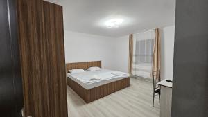 a small bedroom with a bed and a window at Casa de la Dunăre-Dăeni in Dăeni +125 photos