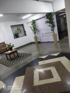 a room with three potted plants on a wall at Souza Lofts Centro Praça Tiradentes in Teófilo Otoni
