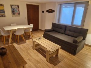 uma sala de estar com um sofá e uma mesa em Casa Laura Bariloche em San Carlos de Bariloche
