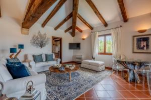a living room with white furniture and a table at Villa Capo Coda Cavallo piscina privata in San Teodoro