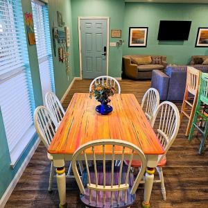 a wooden table with chairs and a vase of flowers on it at Yarbarita's Stay and Play in Rockport