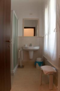 a white bathroom with a sink and a mirror at Agriturismo Il Moro in Gubbio