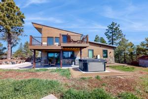 a house with a deck and a stove in the yard at Ponca Lode Retreat in Keystone