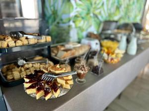 uma linha de buffet com vários tipos de pastelaria e sobremesas em Art-Hotel Del Medio em Sutomore