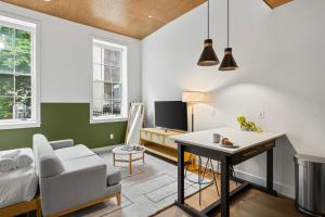 a living room with a bed and a desk and a table at Sosuite at The Loxley - Old City in Philadelphia