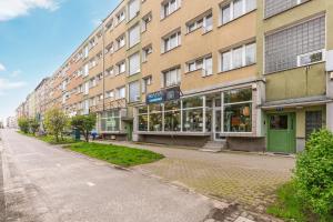 an empty street in front of a building at Wave Apartments - Aurora in Gdynia