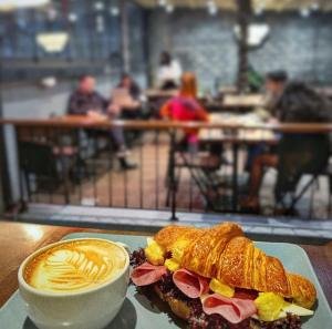 a sandwich and a cup of coffee on a table at Vicolo Otel in Istanbul