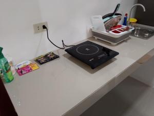 a counter top with a record player and a sink at Boarding house in Guinauayan