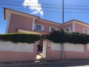 a pink house with trees in front of it at Grace Villa in Aldeia de Juso