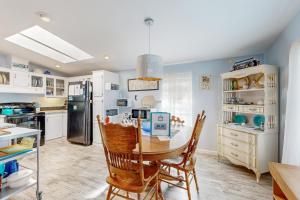 a kitchen with a table and chairs and a refrigerator at Blue Heaven Beach House in Rockaway Beach