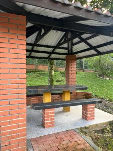 un banco sentado bajo un toldo en un parque en Mirador El paraiso glamping, en Villavicencio