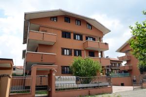 an apartment building with a fence in front of it at [Fiori del Lario] Excl. 110MQ Fiera/Milano/MXP in Cesate