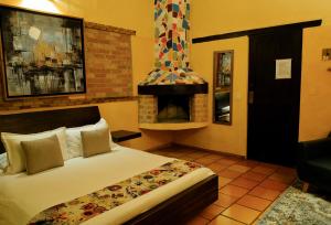 a hotel room with a bed and a fireplace at Elephantia Spa Hotel in Villa de Leyva