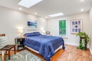 a bedroom with a bed and a table and two windows at Sawyer Retreat with Fire Pit Less Than 2 Mi to Beaches! in Sawyer +22 photos