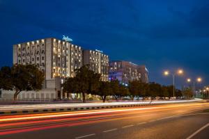 a building on a city street at night at Radisson Hotel Muscat Panorama in Muscat